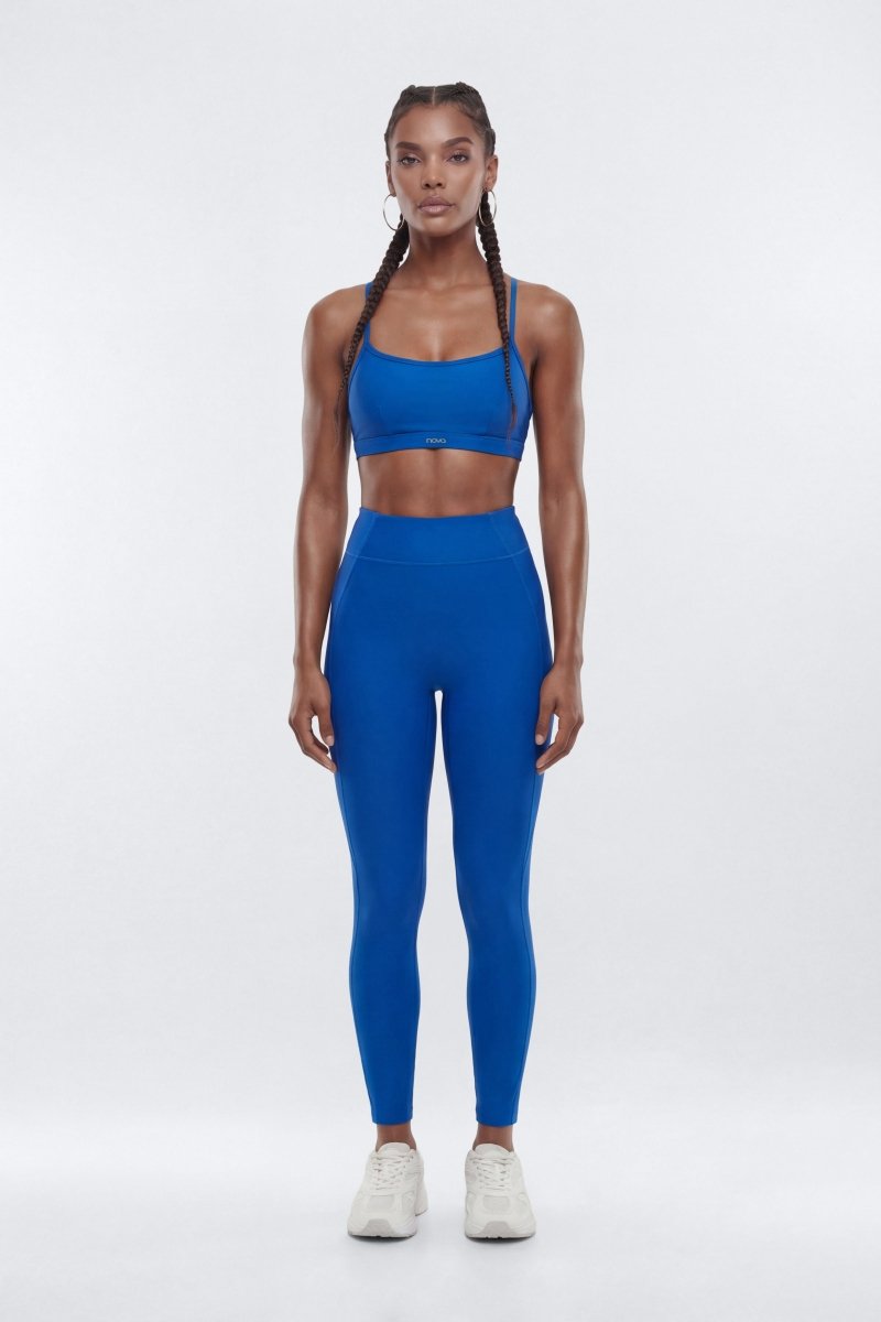 Woman wearing a blue athletic outfit on a white background