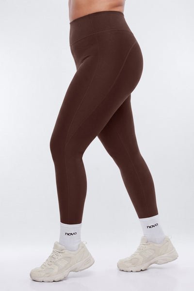 Brown leggings worn by a person on a white background