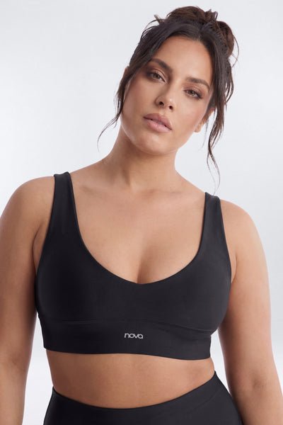 Woman wearing a black sports bra with &