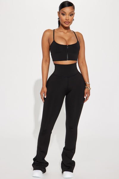 Person wearing a black athletic outfit on a white background