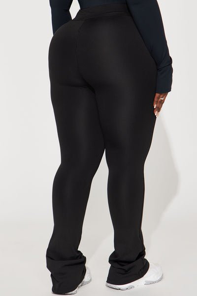Person wearing black pants on a white background