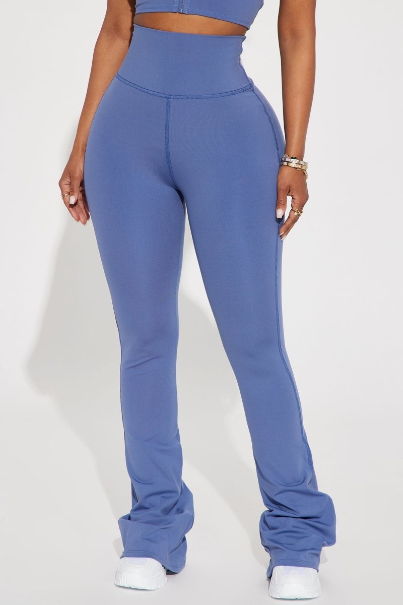 Person wearing blue high-waisted leggings on a white background