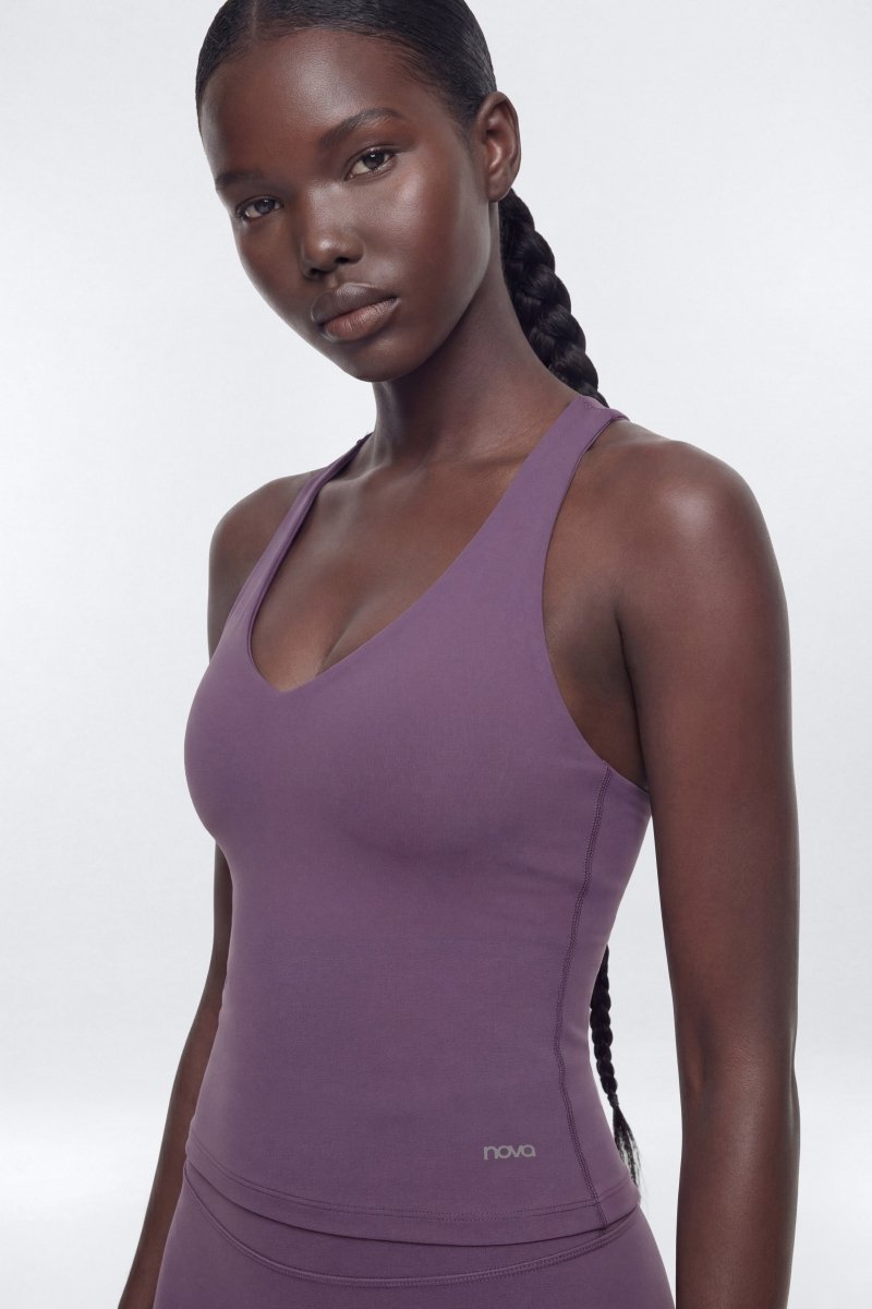 Woman wearing a purple tank top with &