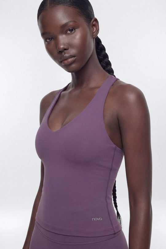 Woman wearing a purple tank top with &