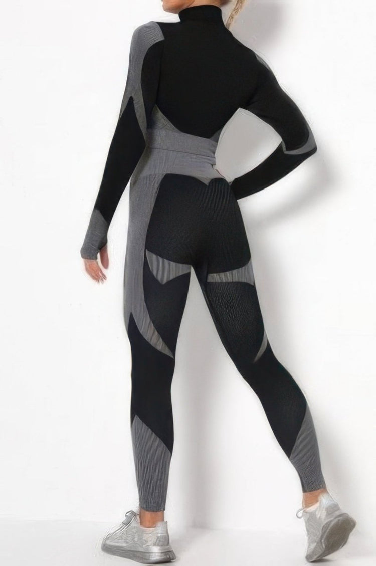 A woman modeling a black and gray long-sleeve full-body compression suit or bodysuit, shown from the back against a plain white studio background.