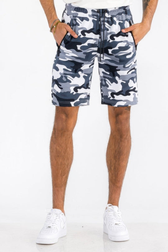Person wearing camouflage shorts on a white background