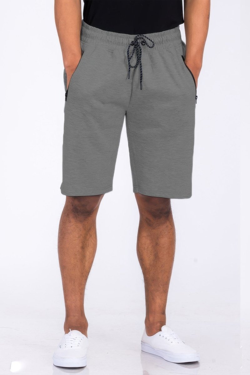 Person wearing gray shorts with a drawstring on a white background