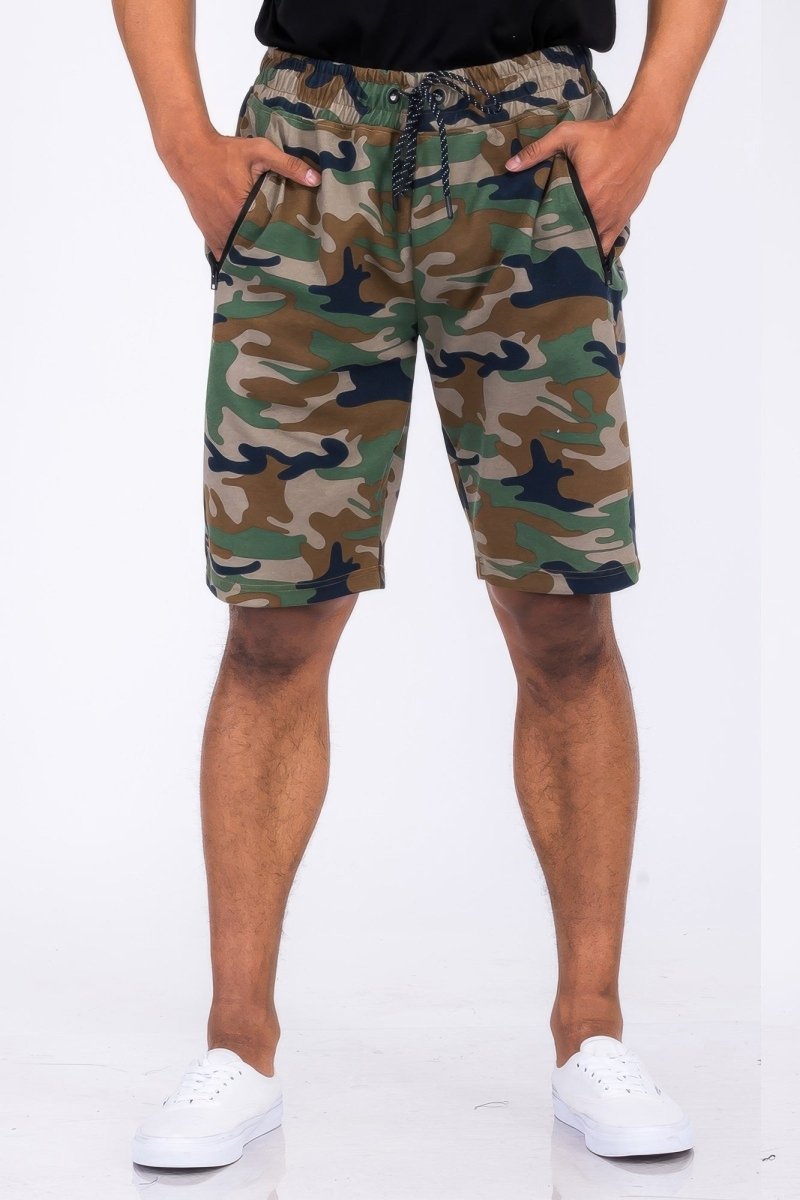 Camouflage shorts worn by a person on a white background