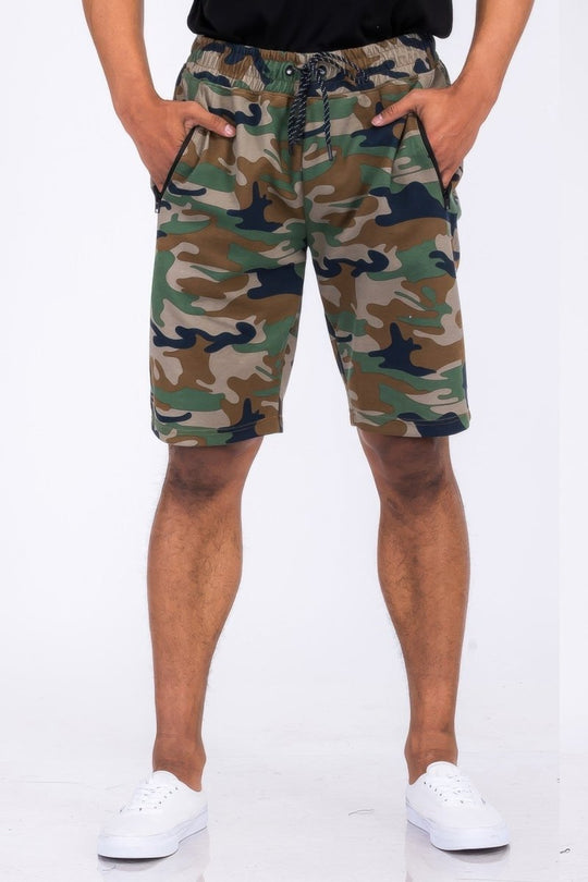 Camouflage shorts worn by a person on a white background