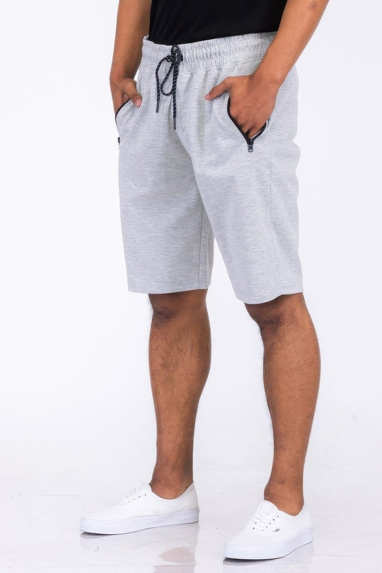 Person wearing gray shorts on a white background