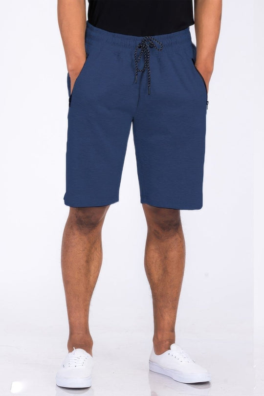 Person wearing blue shorts on a white background