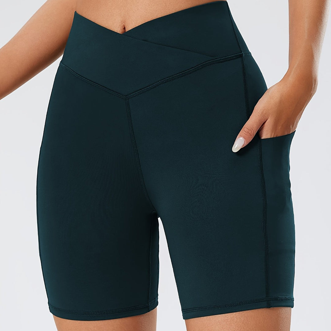 Dark green athletic shorts worn by a person on a light gray background