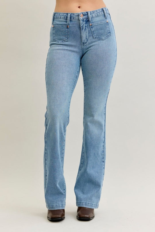 Light blue jeans worn by a person on a plain background