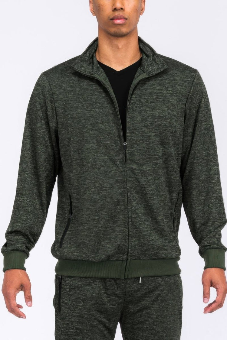 Person wearing a gray tracksuit on a white background