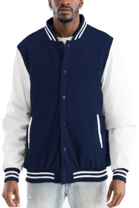 Man wearing a navy and white varsity jacket on a white background