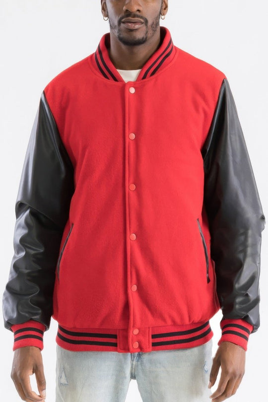 Red varsity jacket with black sleeves worn by a person on a white background