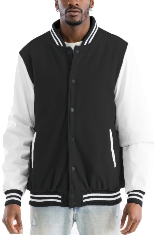 Man wearing a black and white varsity jacket on a white background