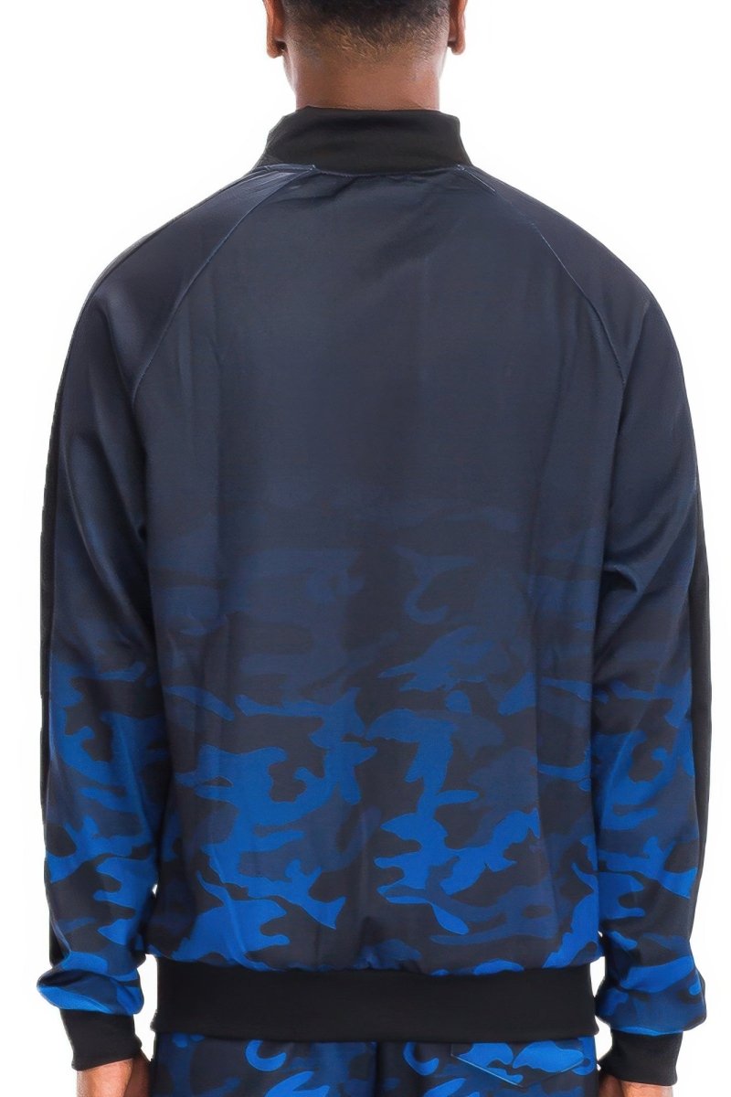 Person wearing a blue and black camouflage jacket on a white background