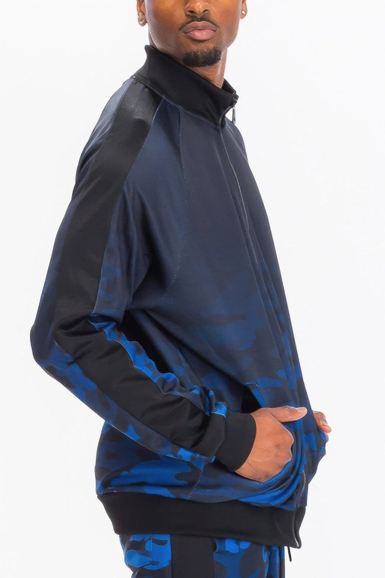 Person wearing a black and blue jacket on a white background