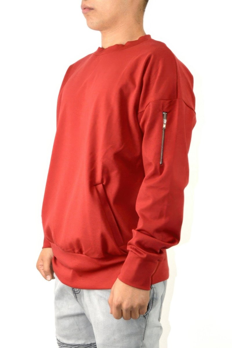 Red long-sleeve shirt worn by a person on a white background