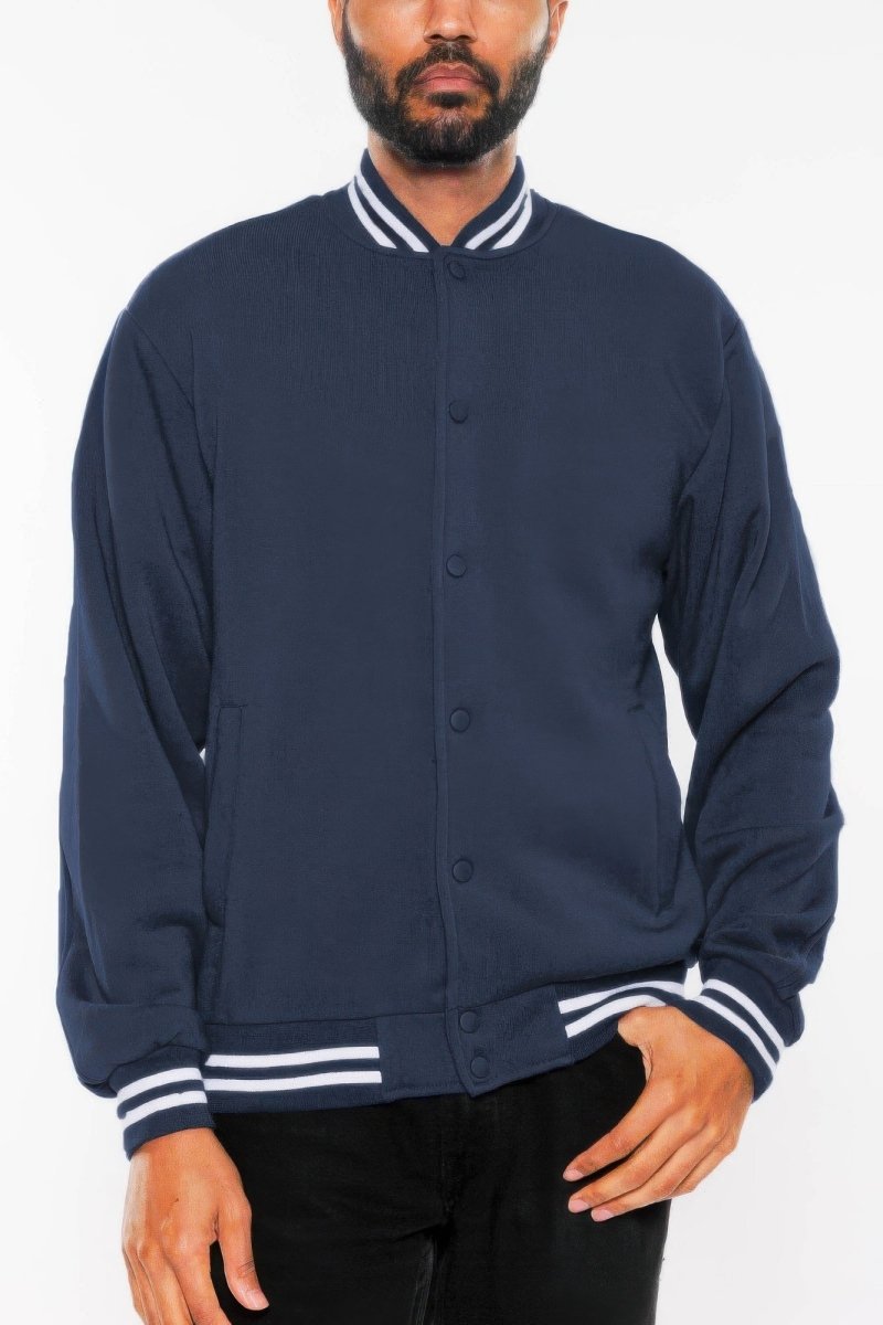 Navy blue jacket with white accents worn by a person on a white background
