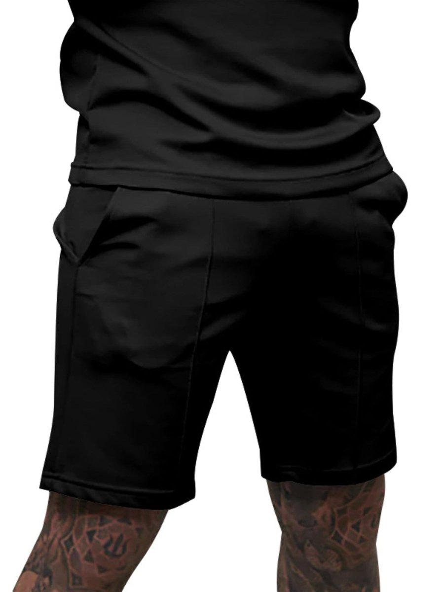 Black shorts worn by a person on a white background