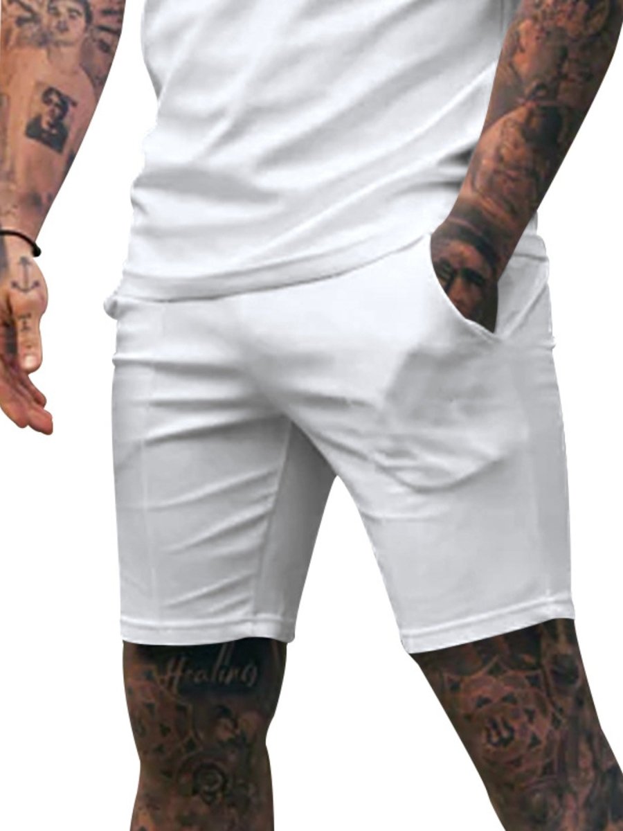Person wearing white shorts with a plain background