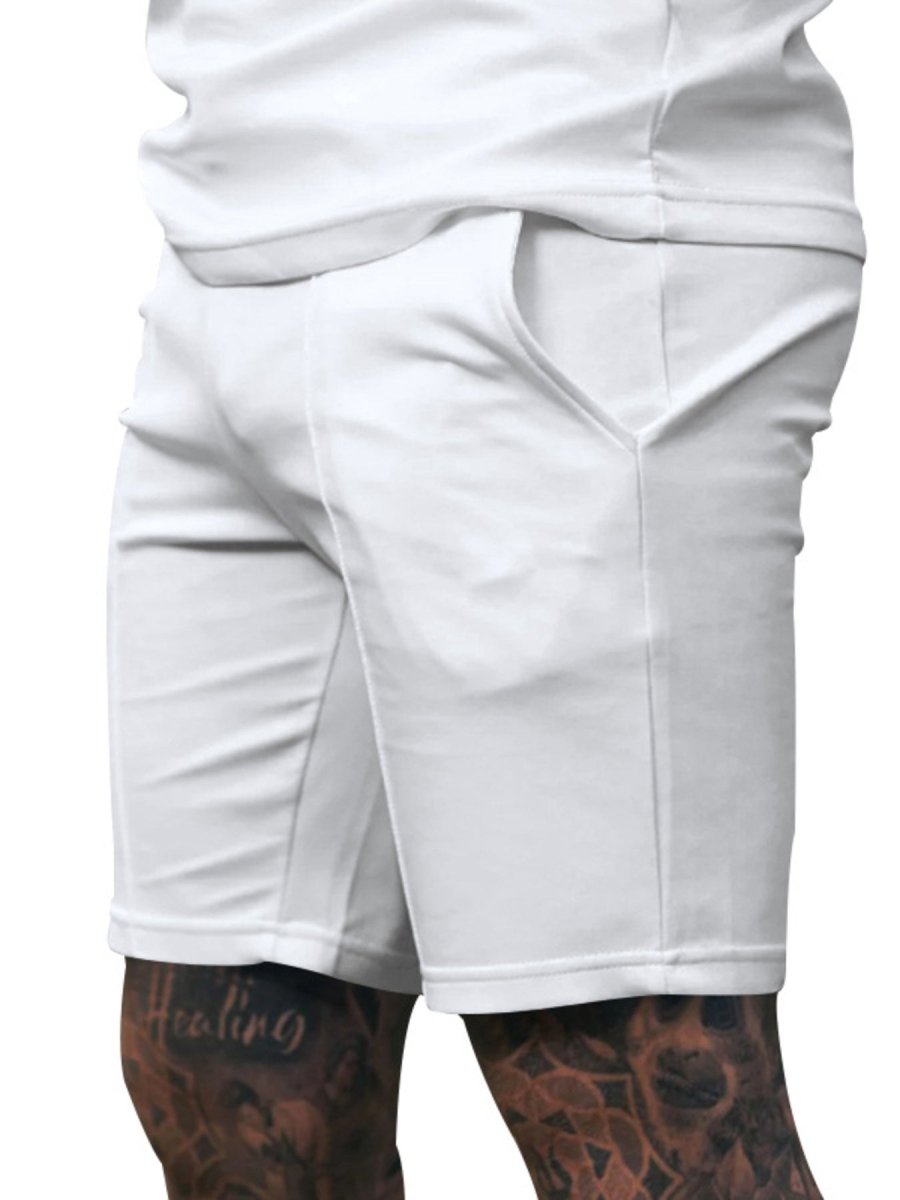 White shorts worn by a person with tattoos on a white background