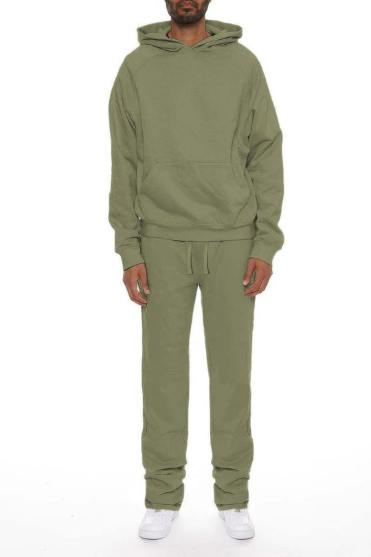 Person wearing a green tracksuit on a white background
