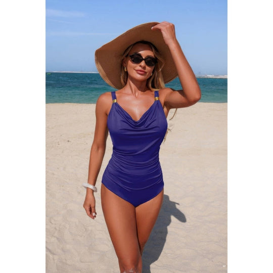 Woman in a blue swimsuit and sun hat on a beach
