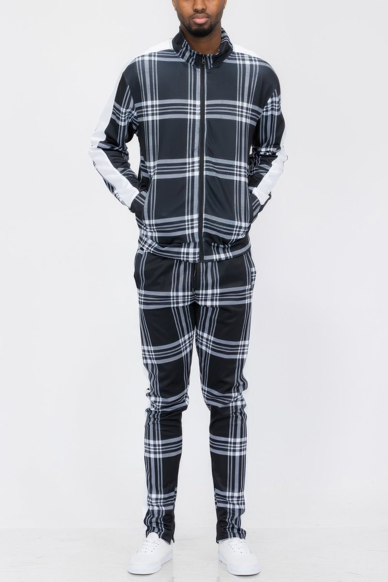 Person wearing a black and white plaid outfit on a white background