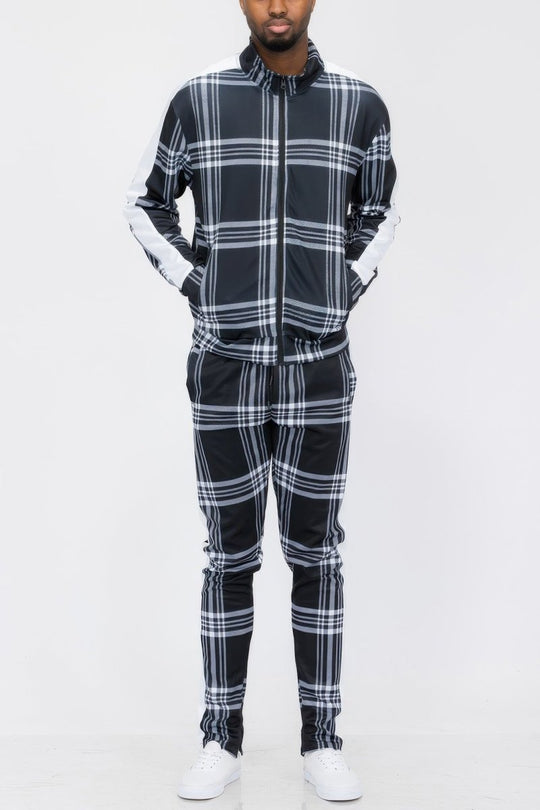 Person wearing a black and white plaid outfit on a white background
