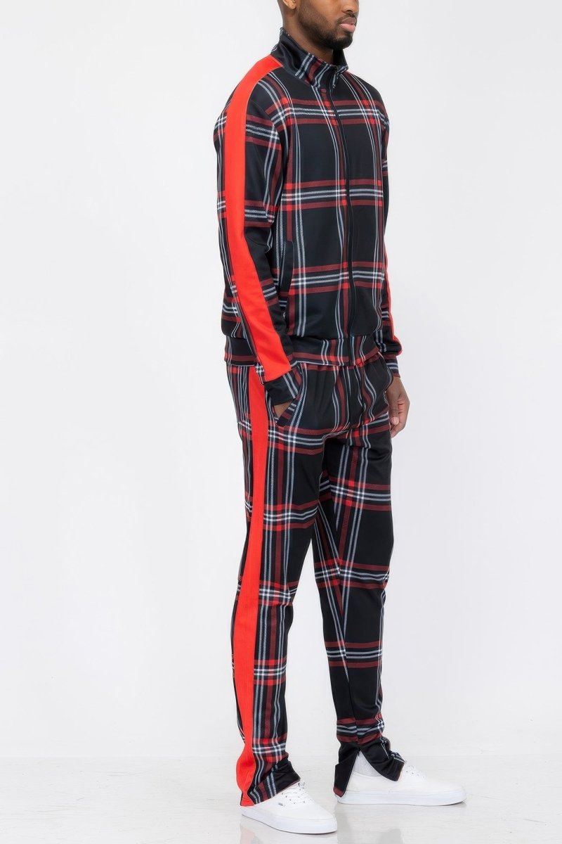 Person wearing a black and red plaid outfit with white sneakers on a white background