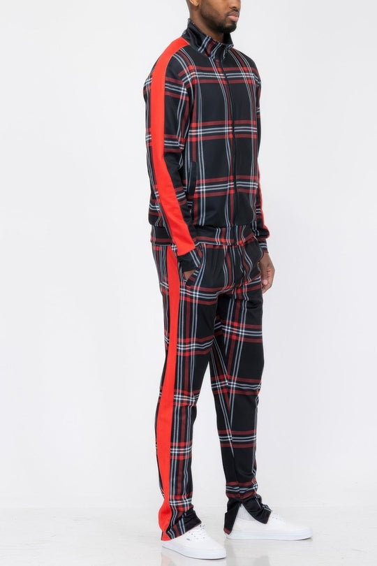 Person wearing a black and red plaid outfit with white sneakers on a white background