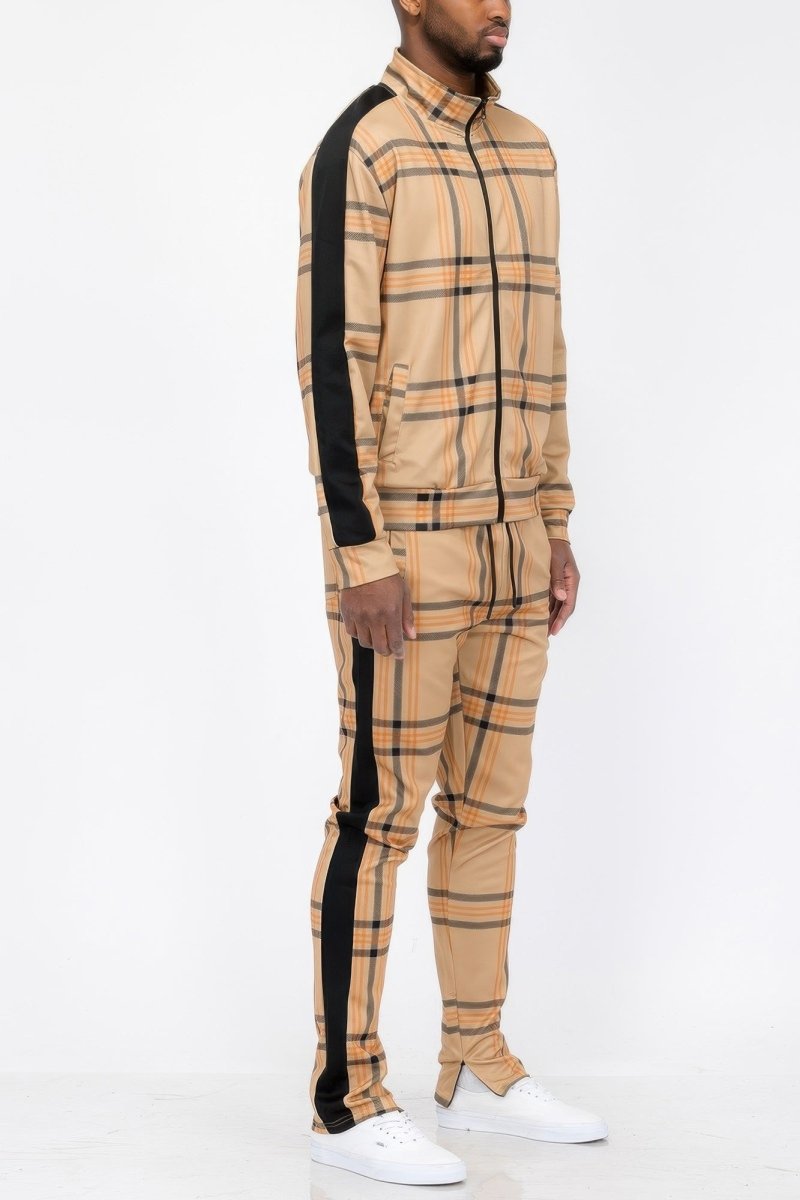 Man wearing a beige checkered outfit with black stripes on a white background