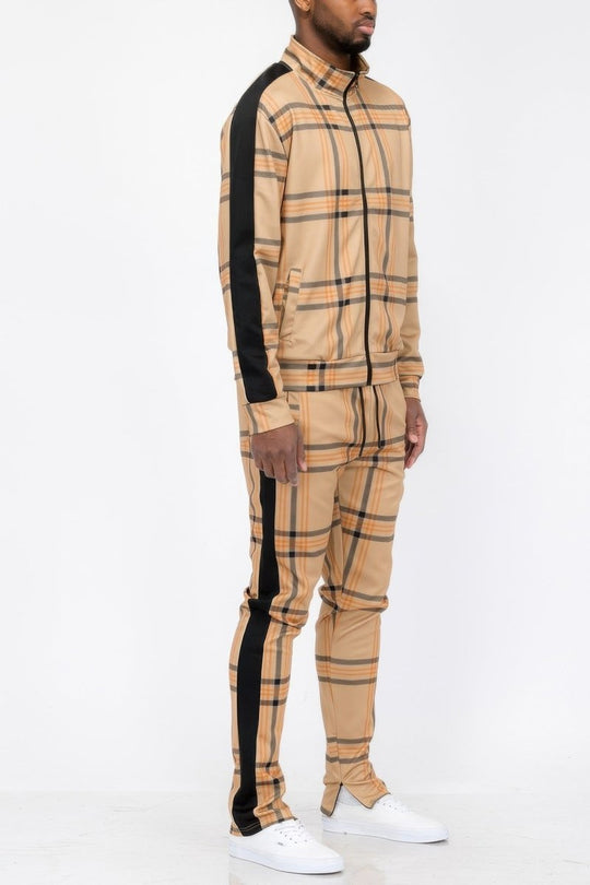 Man wearing a beige checkered outfit with black stripes on a white background