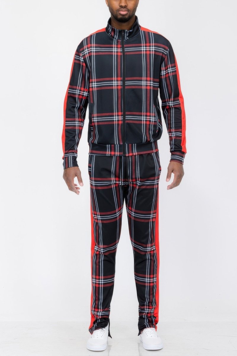 Person wearing a black and red plaid tracksuit on a white background
