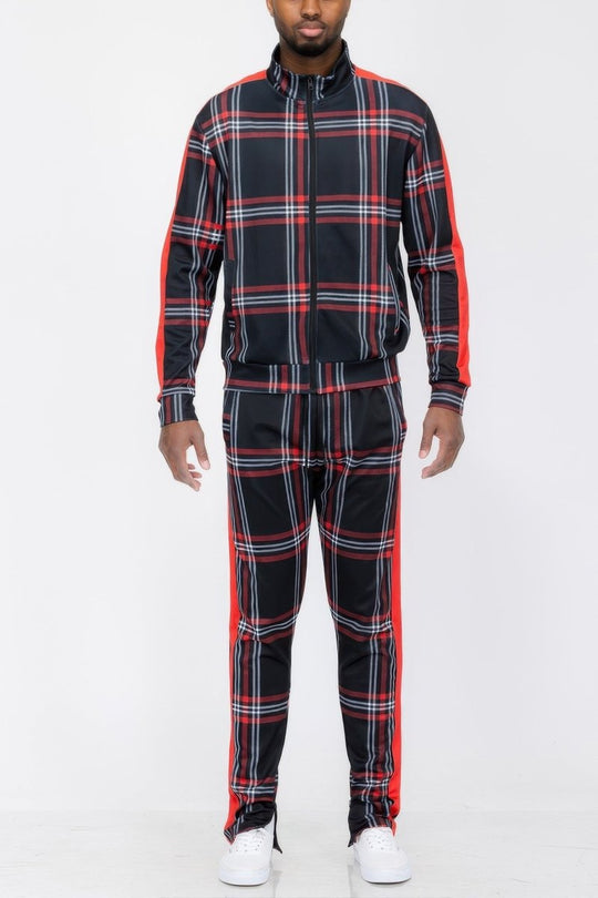 Person wearing a black and red plaid tracksuit on a white background