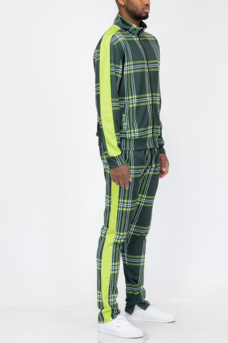 Person wearing a green plaid tracksuit with neon green stripes on a white background