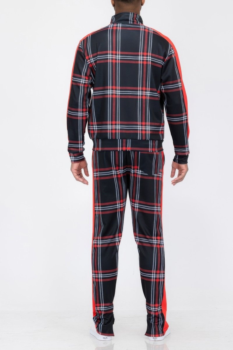 Person wearing a black and red plaid tracksuit on a white background