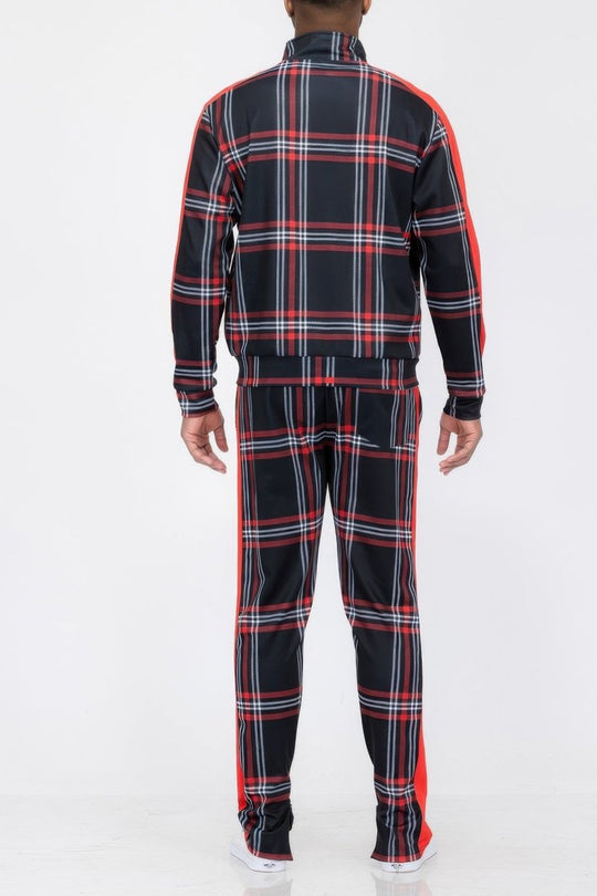Person wearing a black and red plaid tracksuit on a white background