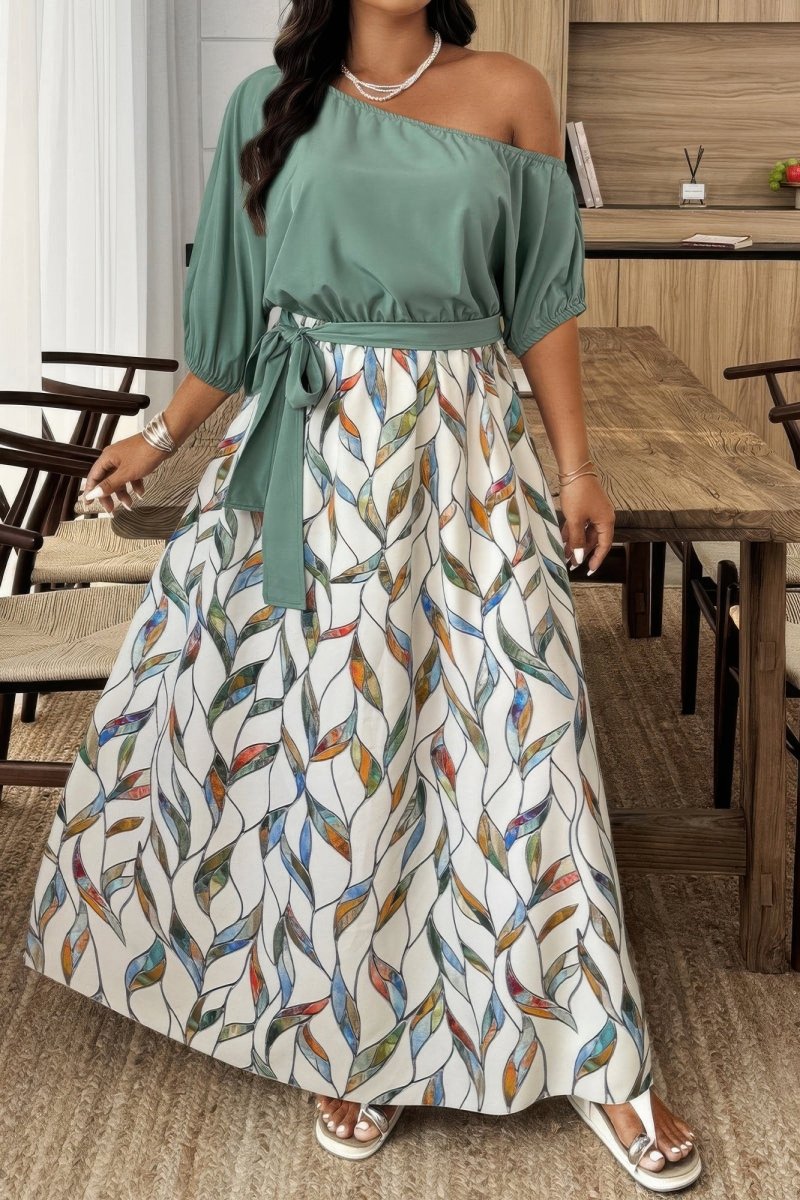 Woman wearing a green top and patterned skirt in a dining area.