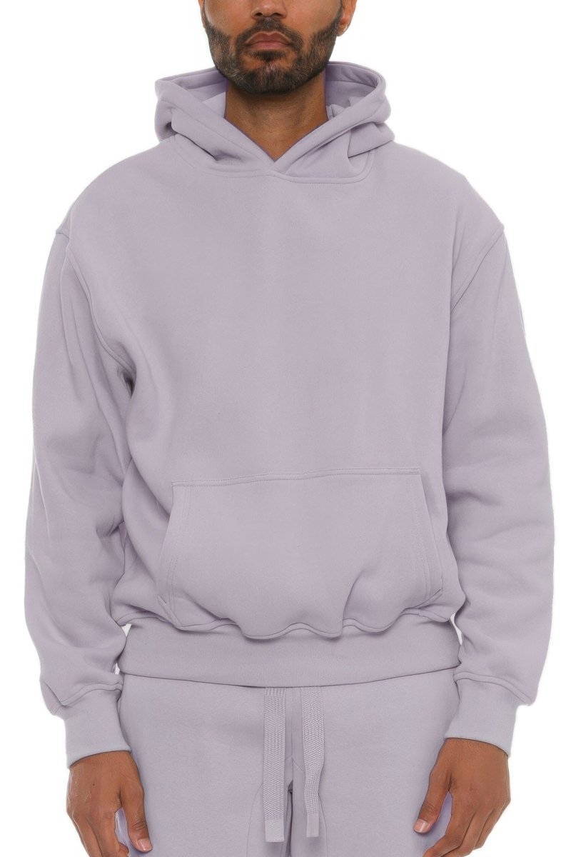 Man wearing a light purple hoodie and pants on a white background