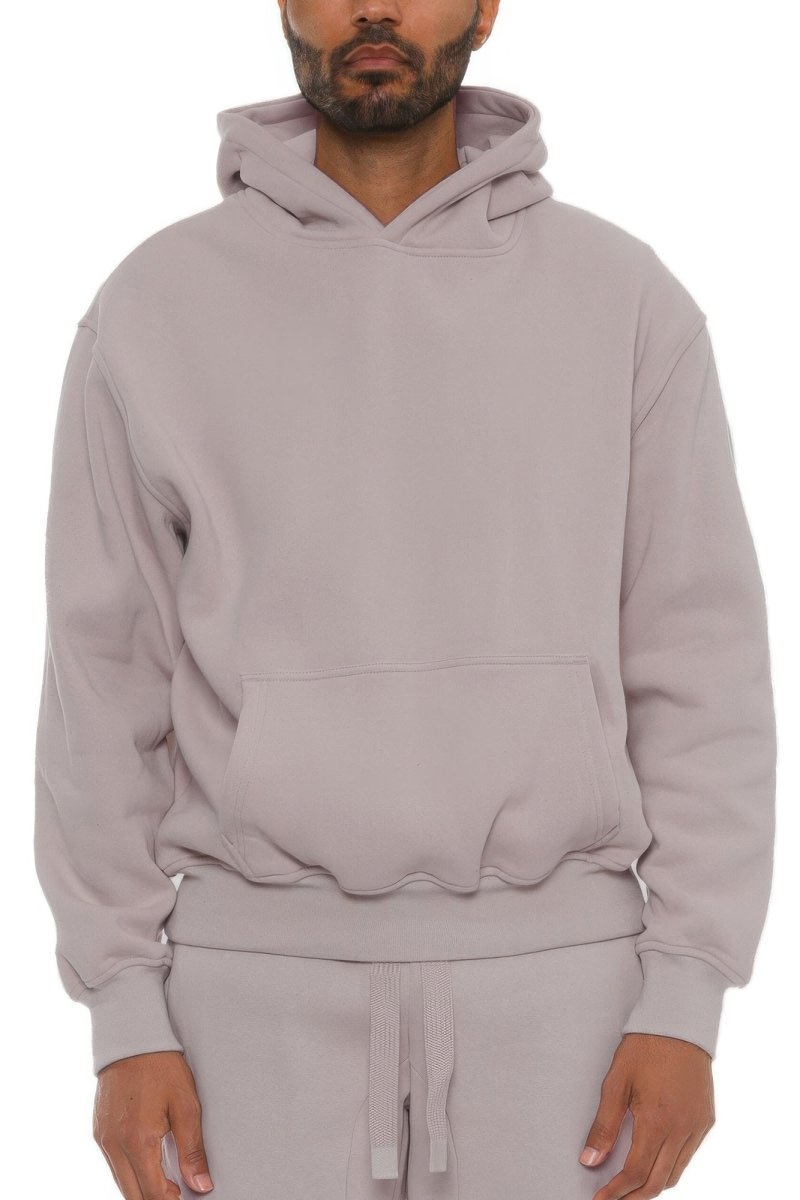 Man wearing a light gray hoodie on a white background