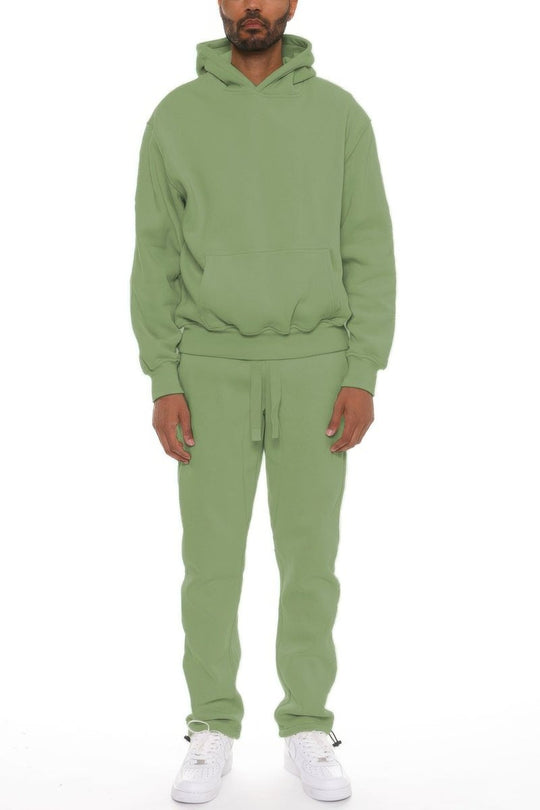 Person wearing a green tracksuit on a white background