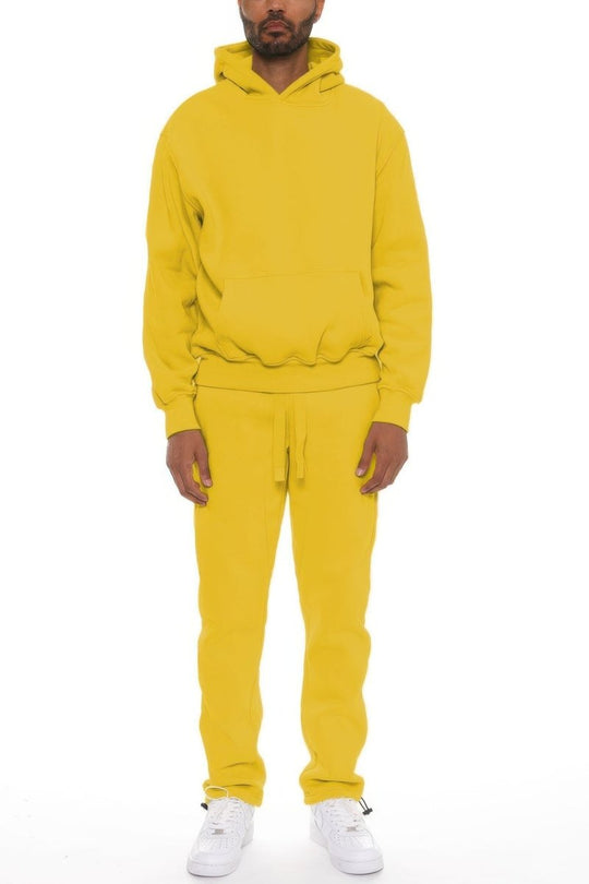 Person wearing a yellow tracksuit on a white background