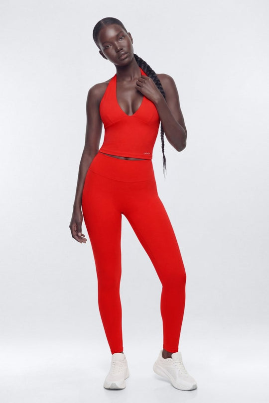 Person wearing a red athletic outfit on a white background