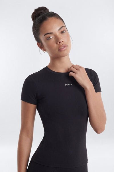 Woman wearing a black t-shirt with a brand logo on a white background