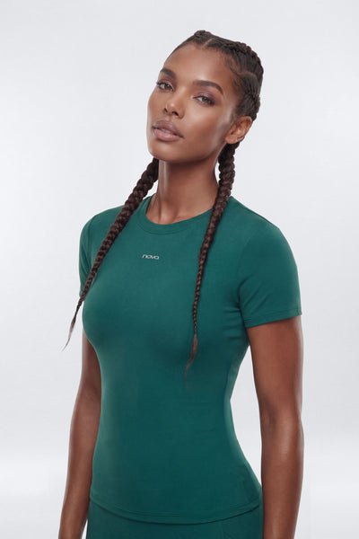 Woman wearing a green athletic outfit on a white background