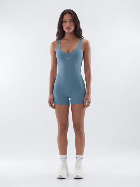 Woman wearing a blue jumpsuit on a white background
